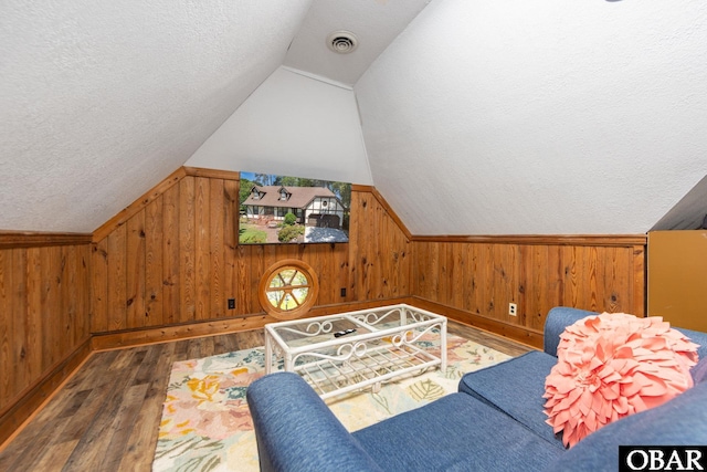 718 Canal Dr Lot 308, Kill Devil Hills, NC 27948 - sitting room featuring wood-type flooring, a textured ceiling, wood walls, lofted ceiling, and baseboards