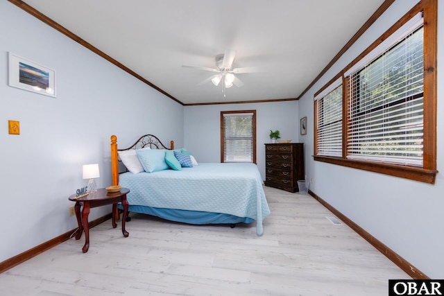 718 Canal Dr Lot 308, Kill Devil Hills, NC 27948 - bedroom with crown molding, baseboards, light wood-style flooring, and ceiling fan