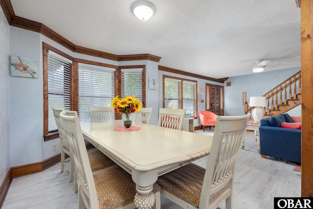 718 Canal Dr Lot 308, Kill Devil Hills, NC 27948 - dining room featuring crown molding, baseboards, light wood-style flooring, stairs, and ceiling fan