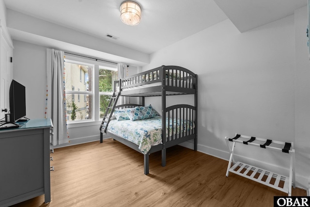 bedroom featuring wood finished floors and baseboards