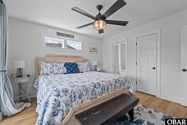 bedroom featuring wood finished floors, baseboards, and ceiling fan