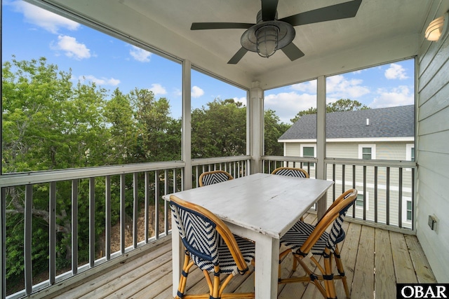 sunroom with ceiling fan and outdoor dining space