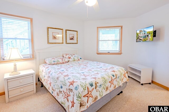 bedroom with baseboards, carpet flooring, ceiling fan, and multiple windows