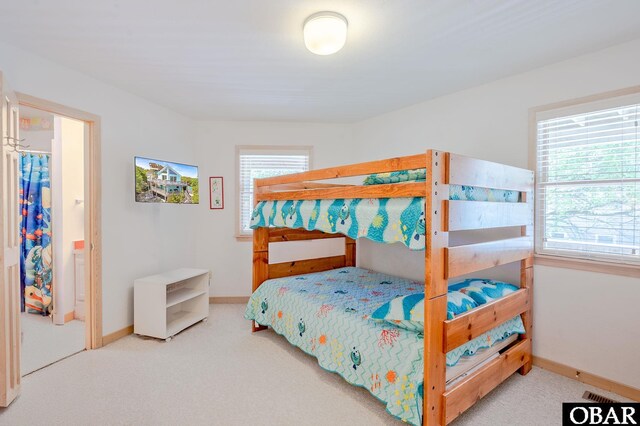 bedroom featuring baseboards, visible vents, multiple windows, and carpet