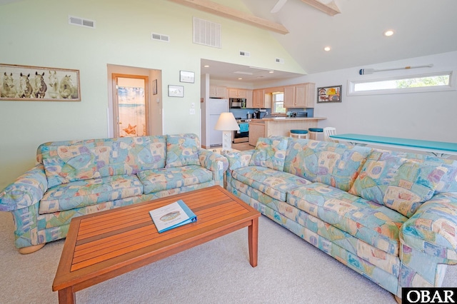 living area featuring visible vents and light carpet