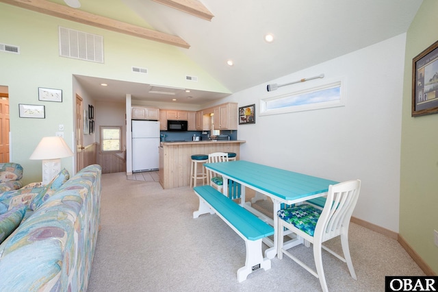 dining space featuring visible vents, beam ceiling, and light carpet