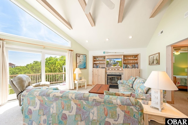 carpeted living room featuring beam ceiling, high vaulted ceiling, a ceiling fan, a high end fireplace, and visible vents