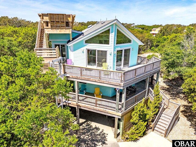 rear view of house with stairs and a deck