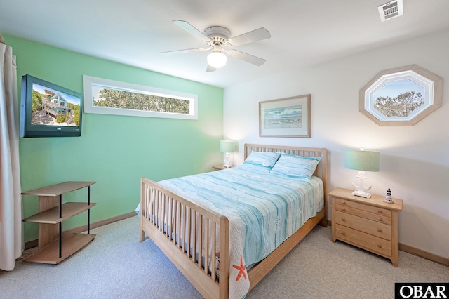 carpeted bedroom with visible vents, baseboards, and ceiling fan