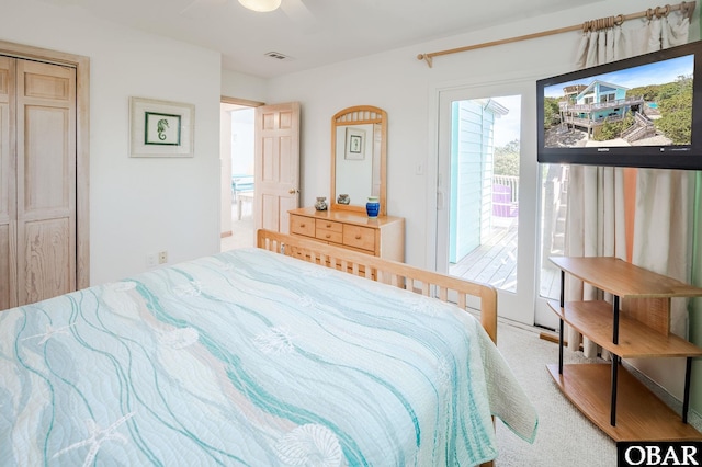 bedroom with visible vents, a ceiling fan, carpet floors, and access to exterior