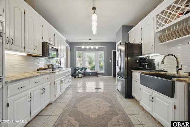 107 Magnolia Dr Lot 75, 76, 77, Camden, NC 27921 - kitchen with a sink, decorative backsplash, white cabinets, a chandelier, and a textured ceiling