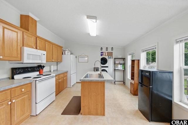 138 Swains Ln Lot 3, Barco, NC 27917 - kitchen featuring white appliances, a sink, a kitchen island with sink, crown molding, and stacked washing machine and dryer