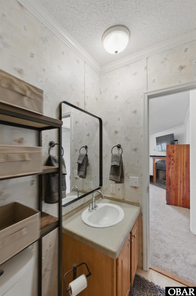 138 Swains Ln Lot 3, Barco, NC 27917 - bathroom with ornamental molding, vanity, a textured ceiling, and wallpapered walls