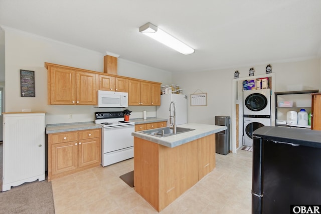138 Swains Ln Lot 3, Barco, NC 27917 - kitchen featuring white appliances, estacked washer and dryer, a sink, light countertops, and a kitchen island with sink