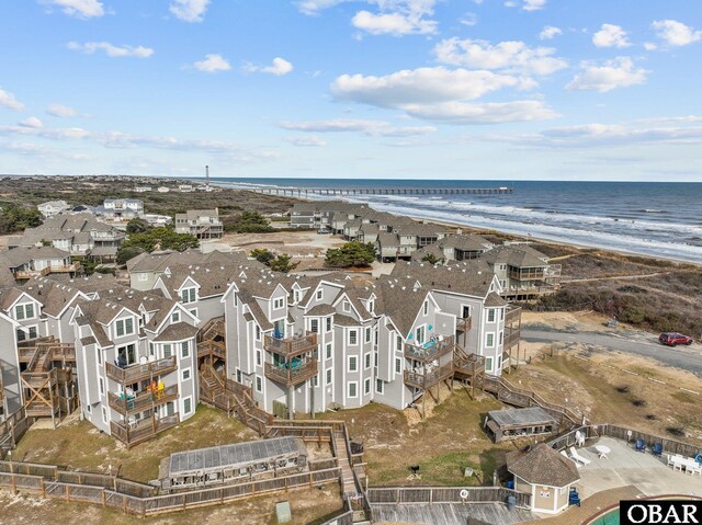 birds eye view of property featuring a water view, a residential view, and a beach view