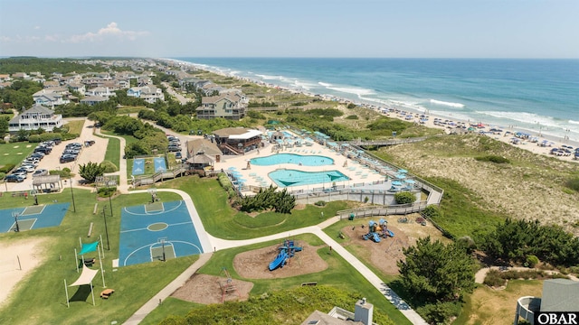 drone / aerial view featuring a water view and a beach view