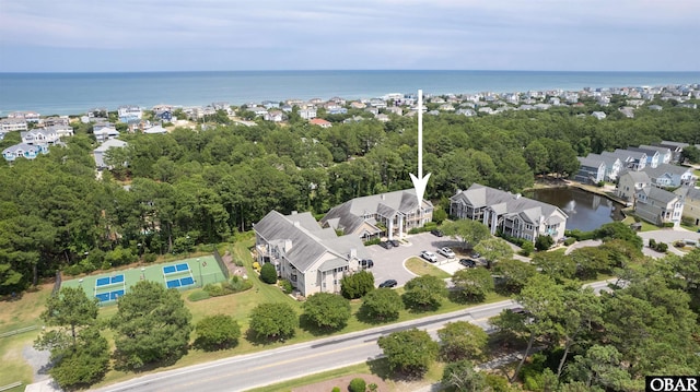 drone / aerial view with a water view and a residential view