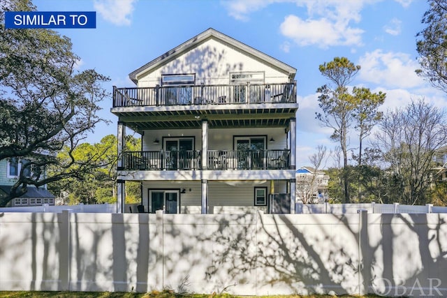 exterior space with a fenced front yard and a balcony