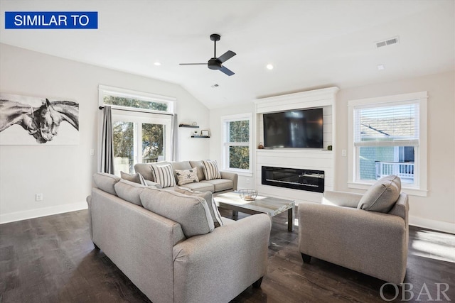 living area with dark wood-style floors, visible vents, a large fireplace, vaulted ceiling, and baseboards