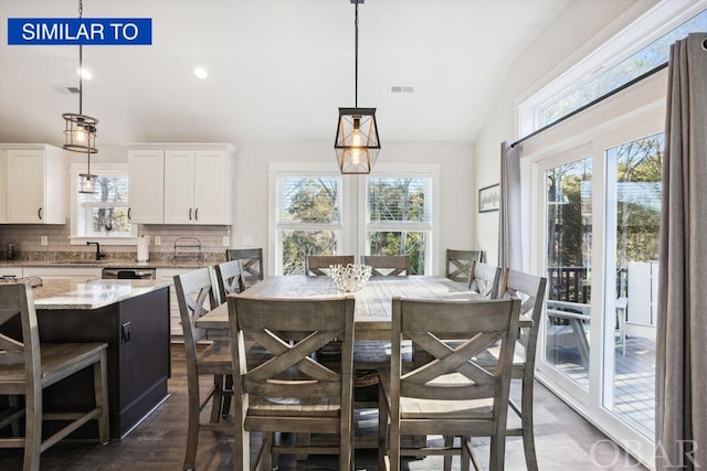 dining space with dark wood-style floors, recessed lighting, visible vents, and vaulted ceiling