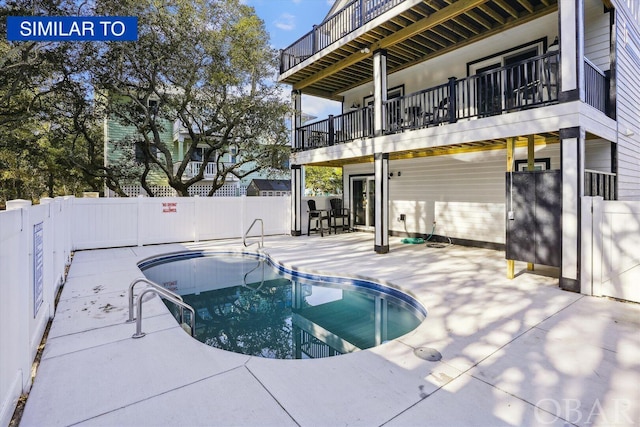 view of swimming pool featuring fence, a fenced in pool, and a patio