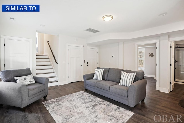 living area featuring baseboards, stairs, visible vents, and dark wood-style flooring