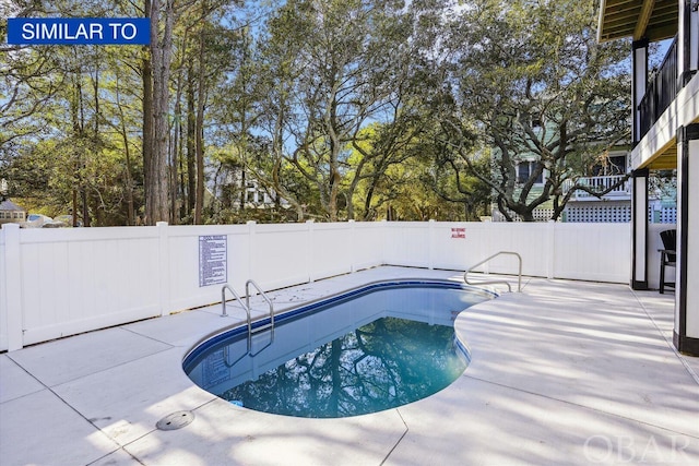 pool with a patio area and a fenced backyard