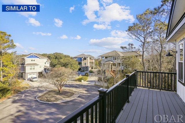 wooden deck featuring a residential view