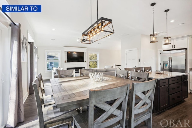 dining space featuring baseboards, dark wood-style flooring, a fireplace, and recessed lighting