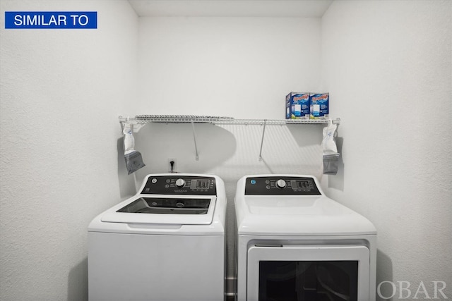 washroom featuring laundry area and washing machine and dryer