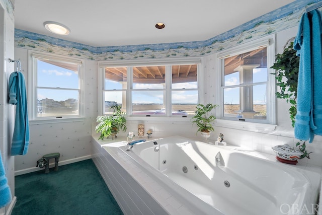 full bathroom featuring a jetted tub, baseboards, and wallpapered walls