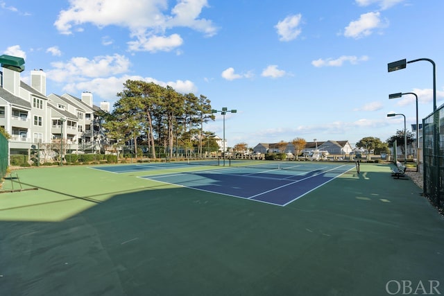 view of tennis court featuring fence