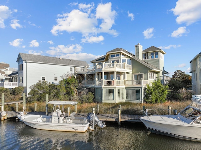 back of property featuring a water view and a chimney