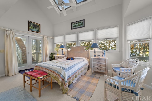 bedroom featuring light carpet, a skylight, access to outside, and high vaulted ceiling