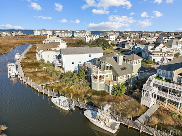 birds eye view of property featuring a residential view and a water view