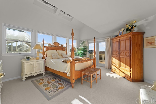 bedroom with access to exterior, light colored carpet, and baseboards