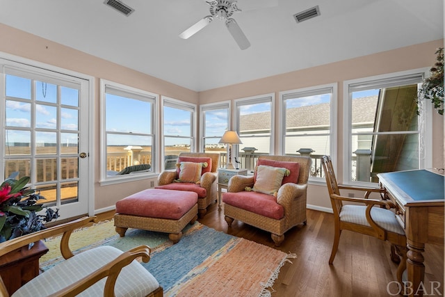 sunroom featuring ceiling fan, lofted ceiling, and visible vents