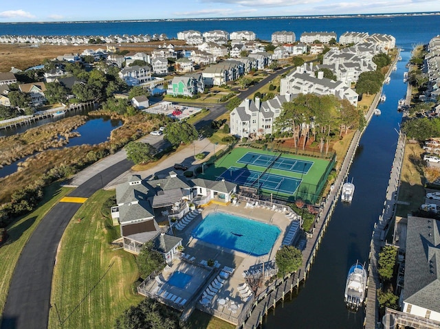 drone / aerial view featuring a residential view and a water view