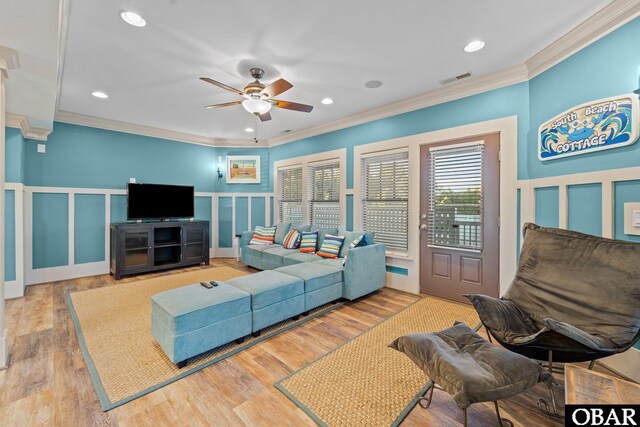 27206 Sea Chest Ct Lot 27, Salvo, NC 27972 - living area featuring a decorative wall, crown molding, ceiling fan, wainscoting, and wood finished floors
