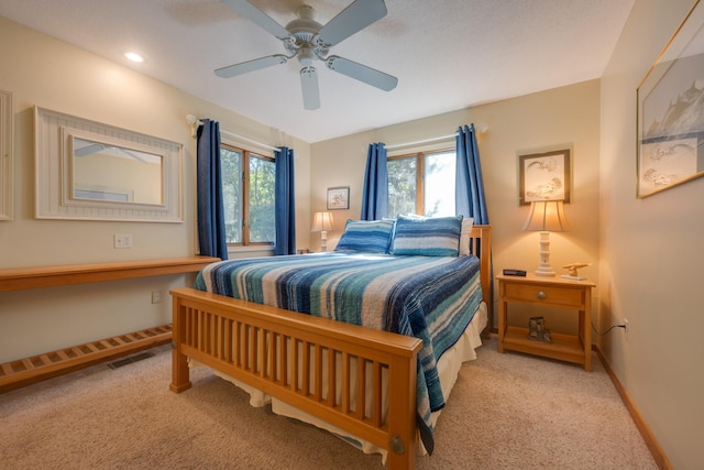 bedroom with ceiling fan, recessed lighting, baseboards, and light colored carpet