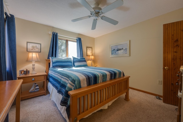 bedroom with ceiling fan, baseboards, and light colored carpet