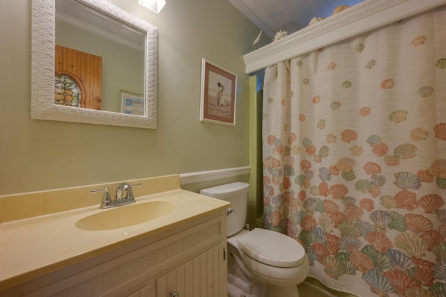 full bath with toilet, crown molding, and vanity