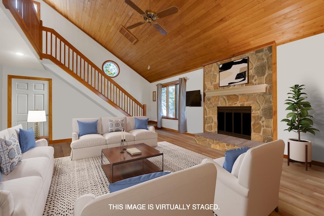 living room with wooden ceiling, light wood finished floors, and a fireplace