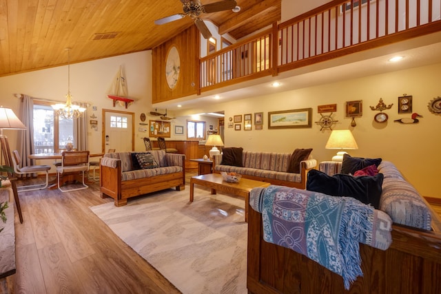 living area with a wealth of natural light, wood ceiling, visible vents, and wood finished floors