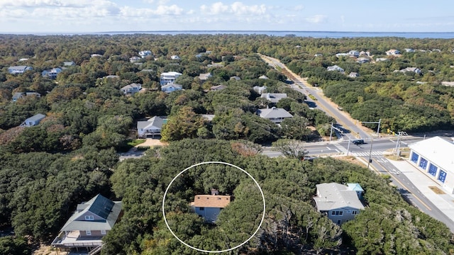 drone / aerial view featuring a residential view and a view of trees