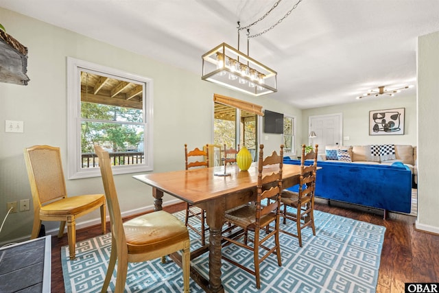 dining room with a healthy amount of sunlight, baseboards, and dark wood-style flooring