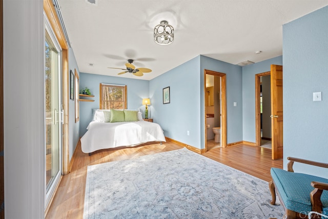 unfurnished bedroom with baseboards, ceiling fan, connected bathroom, and light wood-style floors