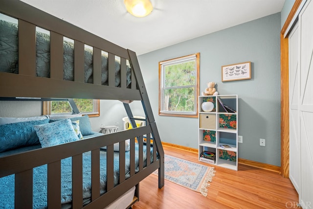 bedroom with baseboards and wood finished floors