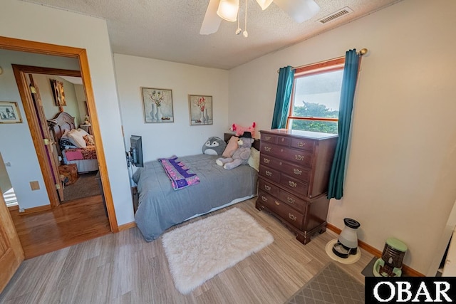 40191 Kiddy Ln Lot 13, Avon, NC 27915 - bedroom featuring light wood-style flooring, a textured ceiling, ceiling fan, and baseboards