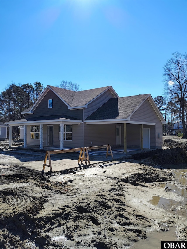 view of front of property featuring roof with shingles